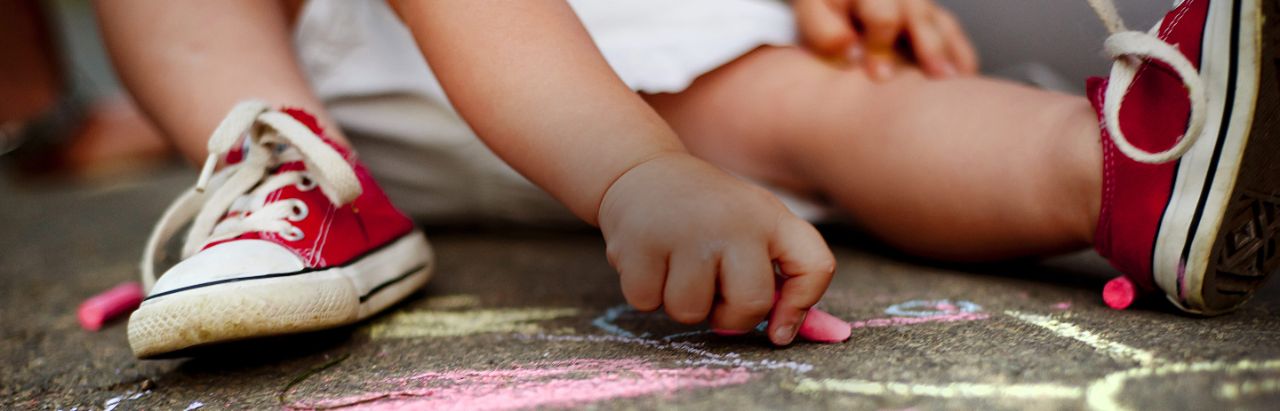 toddler chalk drawing with red shoes